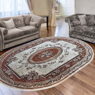 Hnedý oválny koberec so vzorom