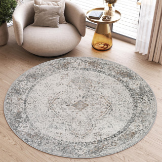 Vzorčasta okrogla preproga v beli barvi