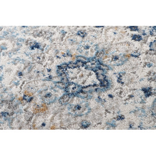 Vzorčasta okrogla preproga v beli in modri barvi