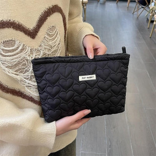 Prešita kozmetična torbica v črni barvi