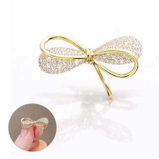 Zlata broška v obliki pentlje s cirkoni