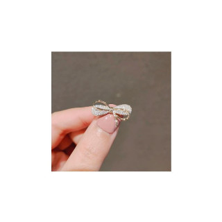 Zlata broška v obliki pentlje s cirkoni